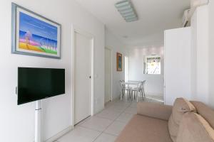a living room with a flat screen tv on a wall at Residence Saint Nicholas in Lido di Jesolo