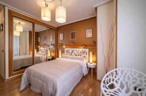 a bedroom with a large bed and a large mirror at Lope de Vega in Zamora
