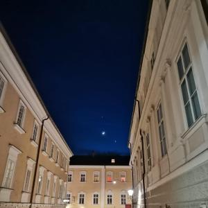 an empty city street at night with a blue sky at arte vida boutique guesthouse in Salzburg