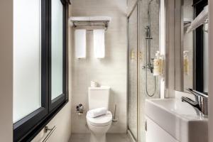 a bathroom with a toilet and a sink and a shower at Empire Marquês Hotel in Lisbon