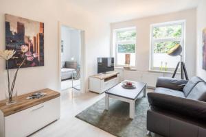 a living room with a couch and a table at City Apartment Lüneburg in Lüneburg