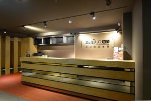 a restaurant with a smileergy sign on the wall at Smile Inn - Taipei Main Station in Taipei