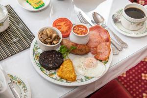 a plate of breakfast food on a table at Beaumont Guest House - FREE off-site Health Club - Adults Only in Windermere