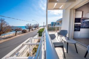 a balcony with chairs and a view of the ocean at Luci Apartment Sea Beach in Avola
