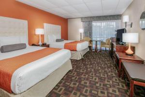 a hotel room with two beds and a television at Howard Johnson by Wyndham Oklahoma City OKC Airport, Fairgrounds, I40 in Oklahoma City