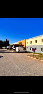 a car parked in a parking lot next to a building at My KB Hôtel Montélimar in Saulce-sur-Rhône