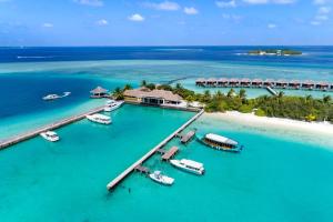 an aerial view of a resort with boats in the water at Sheraton Maldives Full Moon Resort & Spa in North Male Atoll