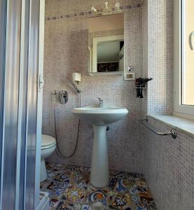a bathroom with a sink and a toilet at Villa La Lanterna in Pietra Ligure