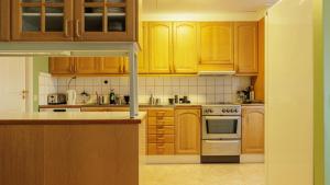 a kitchen with wooden cabinets and a stove top oven at Lovely house in Abisko in Abisko +28 photos