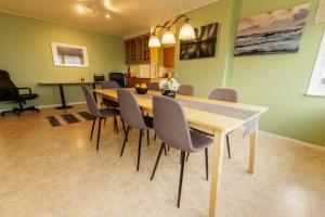 a dining room with a wooden table and chairs at Lovely house in Abisko in Abisko