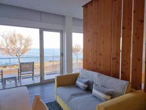 a living room with a couch and a view of the ocean at Bay House - Seascape Apartment in Ponta Delgada