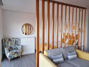 a living room with a couch and a bedroom at Bay House - Seascape Apartment in Ponta Delgada