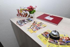 a desk with a table with pictures and a pen at Jajce Youth - Camp and Accommodation in Jajce