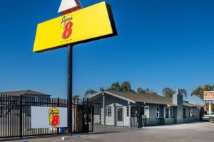 a sign for a fast food restaurant in front of a building at Super 8 by Wyndham Bakersfield CA in Bakersfield