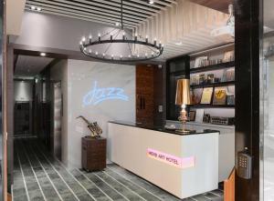 a store lobby with a reception desk and a lamp at Herb Art Hotel in Keelung