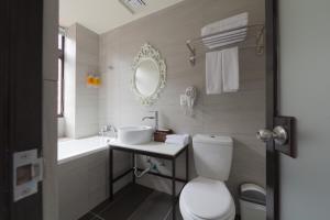 a bathroom with a toilet and a sink and a mirror at Herb Art Hotel in Keelung +18 photos