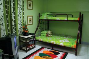 a bedroom with a bunk bed with a teddy bear on it at Pacific Pensionne in Cebu City