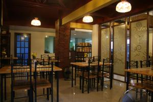 a restaurant with tables and chairs in a room at Pacific Pensionne in Cebu City