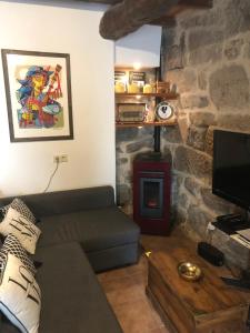 a living room with a couch and a fireplace at Casa Anduriña in Ourense