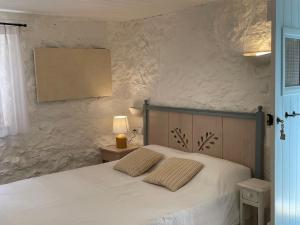 - un lit avec 2 oreillers dans une chambre dans l'établissement Maison PORTOKALIA, à Mixórrouma