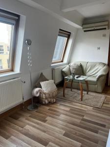 a living room with a couch and a table at Quirky studio flat selfcontained in London