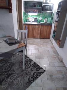 a kitchen with a table and a chair and a counter at Monteur-Ferienwohnung OT Naundorf in Naundorf