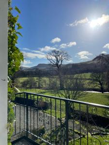 a balcony with a view of a field at River View Knockraich Farm in Fintry