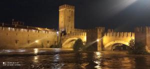 a castle at night with a bridge and a tower at Casetta dei nonni in Pescantina