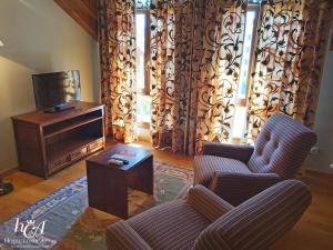 a living room with two chairs and a television at Conde Aznar in Jaca