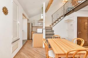 a kitchen and dining room with a wooden table and chairs at Mamma mia, Terre Marine in Bonassola +10 photos