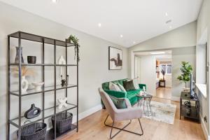 a living room with a couch and a chair at Charming Wimbledon 3-Bed Apt with Outdoor Area in Wimbledon