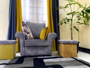 a chair and a plant in a living room at Splendid stay in Nakuru in Nakuru