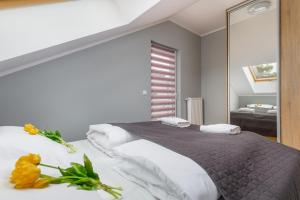 a bedroom with a large bed and a mirror at Apartment Rybacka with Parking&Balcony by Renters in Międzywodzie