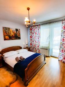a bedroom with a large bed and a large window at Gościna U kowala in Lachowice