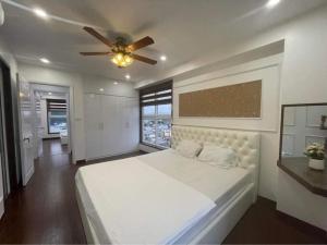 a bedroom with a large bed with a ceiling fan at (Best Seller) Very nice 3 bedroom apartment in Ha Long in Ha Long