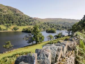 a view of a lake from a rock wall at Highfield Lodge in Windermere
