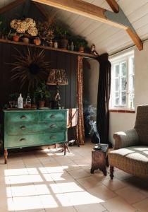 a living room with a green dresser and a couch at Spinks Nest in Hunworth