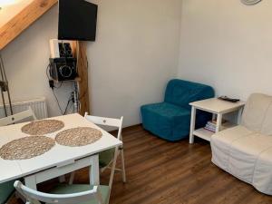 a living room with a table and a couch at Sky view Condo - Klimatyzacja, parking in Tarnowskie Góry