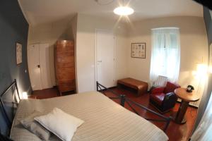 a bedroom with a bed and a red chair at BBQ Lodge in Camogli