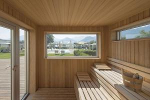 a porch with two benches and a window at Seven Park Hotel Lake Como - Adults Only in Colico