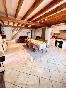 a kitchen with a table and chairs in a room at Gîte Le Rouge Queue 3 étoiles in Fresnes