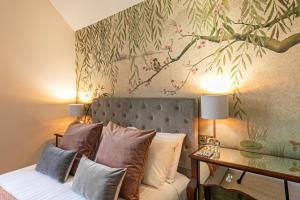 a bedroom with a bed and a painting on the wall at Afon View in Betws-y-coed