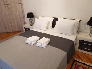 a bedroom with a bed with two towels on it at Kabana Suite Thessaloniki in Thessaloniki