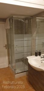 a bathroom with a glass shower and a sink at Casa Tua a Porta Maggiore in Rome