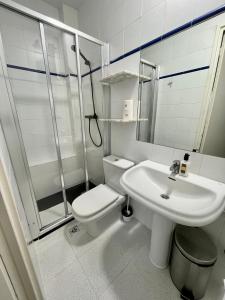 a bathroom with a toilet and a sink and a shower at Madison Rooms in Sitges +39 photos