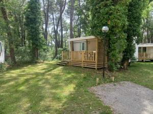 a small cabin in a yard with a porch at Famille Peeters in Camiers