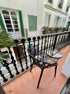 a bench sitting in front of a fence at Madison Rooms in Sitges