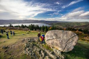 a group of people standing next to a large rock at The Rostrevor Inn in Rostrevor