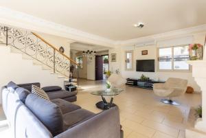 a living room with a couch and a staircase at Villa Andree in Paralimni