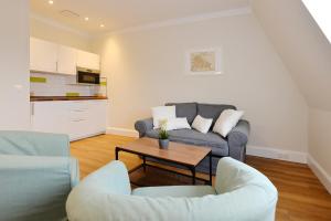 a living room with a couch and a table at Hotel Stralsund in Stralsund +65 photos